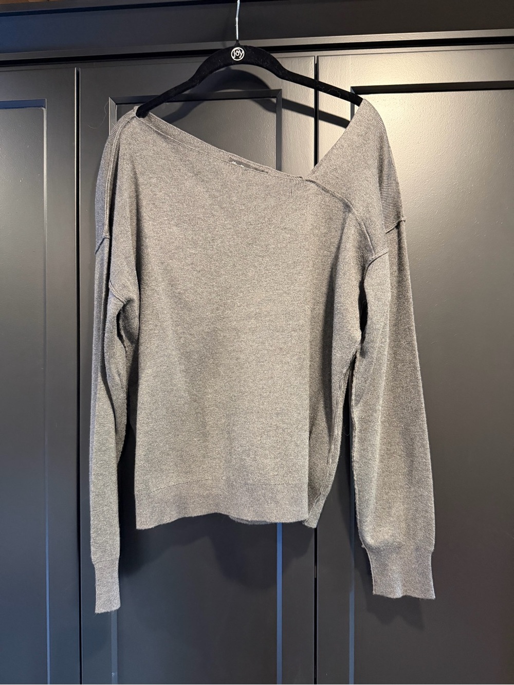 Women’s light-grey asymmetrical neck long-sleeve sweater.